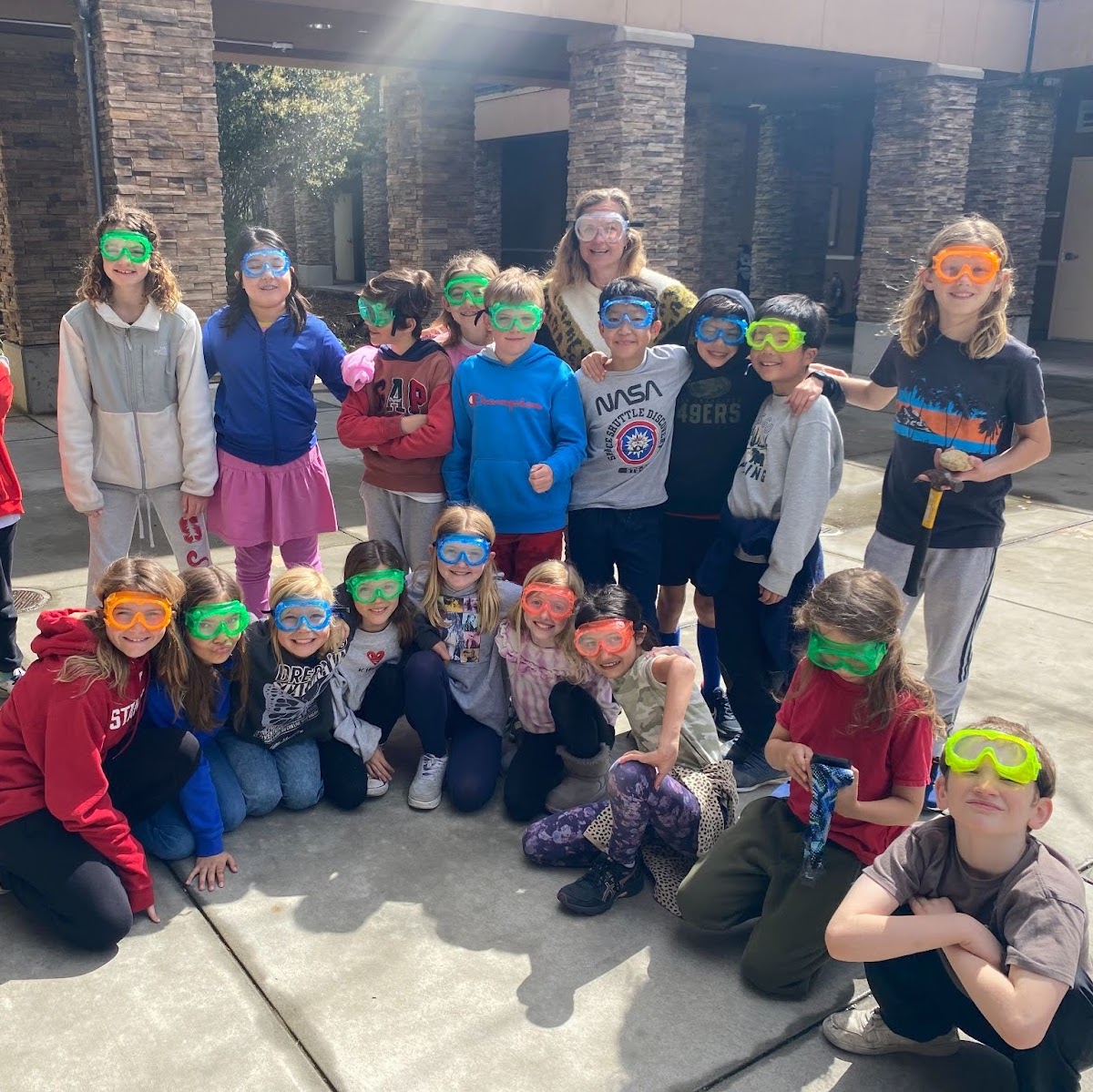 Students smiling and wearing swim goggles